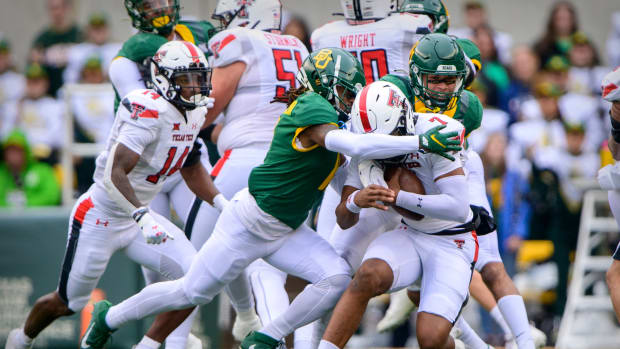 Texas Tech Red Raiders quarterback Donovan Smith (7) is sacked by Baylor Bears safety Jalen Pitre (8) and safety Lorando Johnson (11) during the first half at McLane Stadium.
